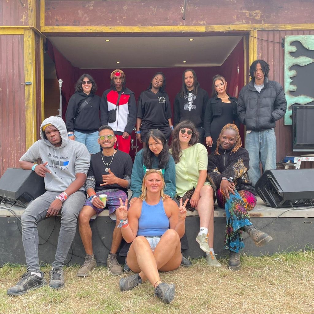 Group of young people sat on a stage at Glastonbury festival