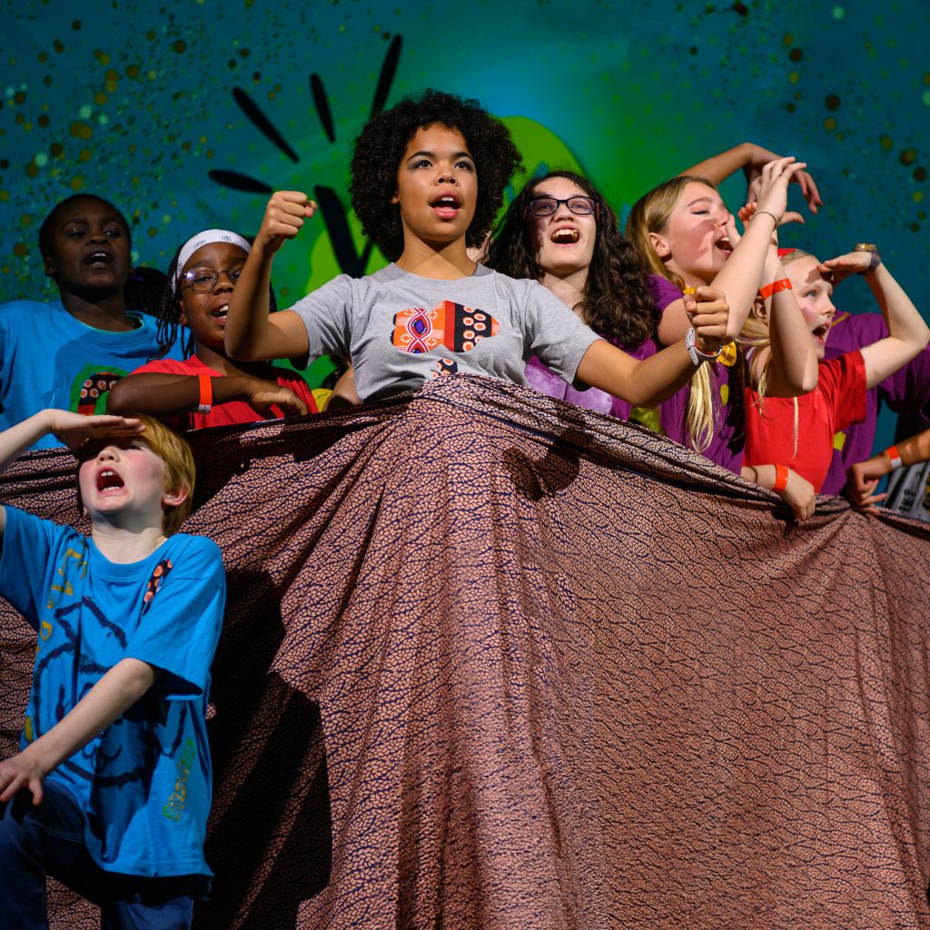 Children performing theatre on stage in